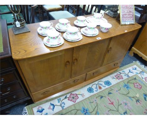 GOOD RETRO BLONDE ERCOL SIDEBOARD with three cupboards enclosing shelving above two long drawers, height 75cms width 130cms