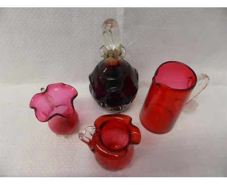 VICTORIAN CRANBERRY GLASS WARE comprising jug and two frilly rim jugs, plus a ruby glass decanter with stopper (4)