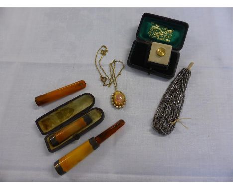 FIRE OPAL DROP PENDANT and three amber cheroot holders, two with silver collars (4)