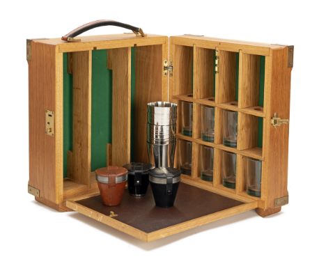 A BRASS-CORNERED OAK TANTALUS OR DRINKS CABINET, partitioned for three 750 cl bottles, twelve tumblers, drop-down leather-bou