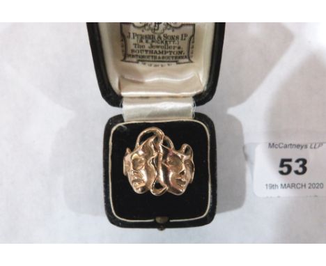 A yellow metal tragedy/comedy mask ring. Size P