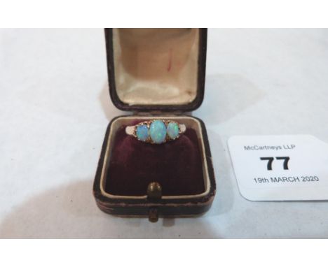 A three stone opal ring. In gold but apparently unmarked. 2.6g gross. Size N½