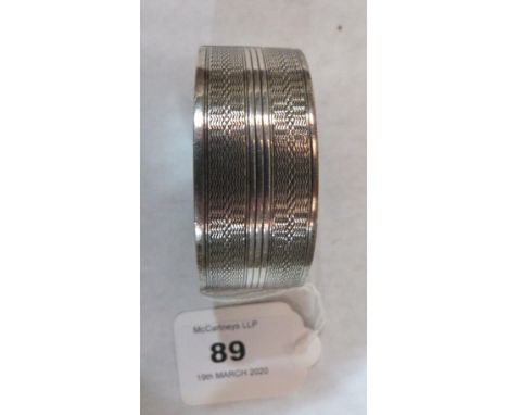 A silver engine turned hinged bangle. Birmingham 1934