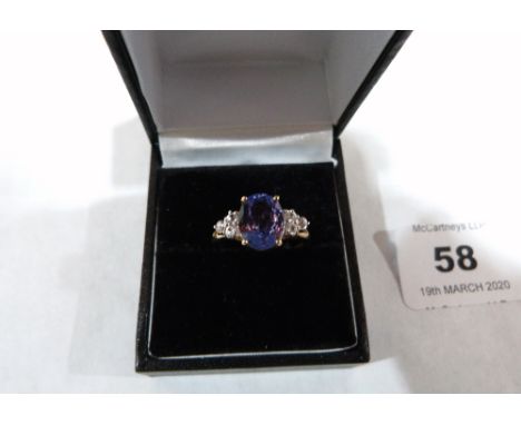 A blue and white stone ring. In gold marked 375. 2.4g gross. Size O½