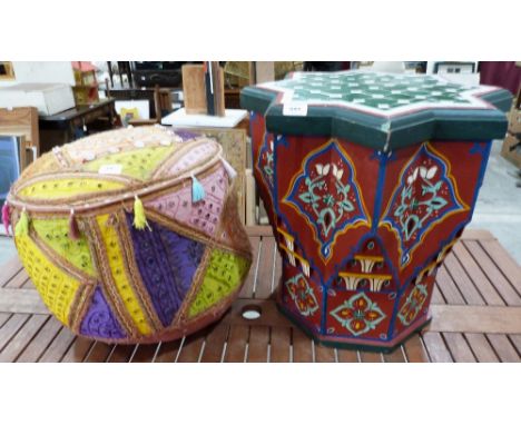 An Indian pouffe decorated with cowrie shells and a painted Moroccan occasional table