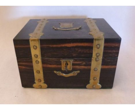 A Victorian coromandel two division tea caddy with applied brass strapwork, escutcheon and cartouche. 8¼' wide
