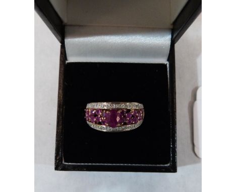 A ruby and white stone ring. In gold marked 9K. 3.1g gross. Size N