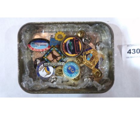 A tin of enamel badges