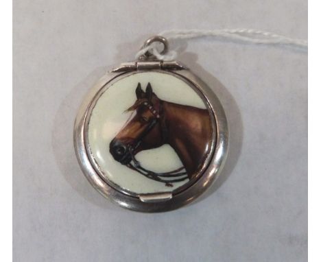 A white metal patch box pendant, the lid with a horse head in enamel and interior mirror