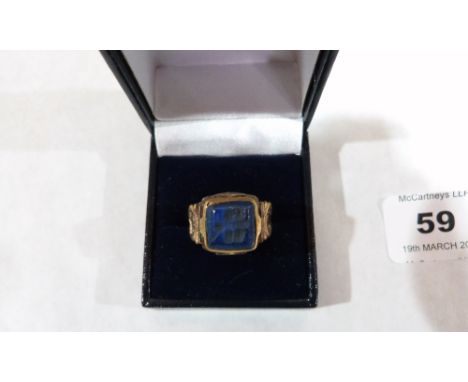 An ISlamic gilt metal blue stone intaglio ring. Size K½