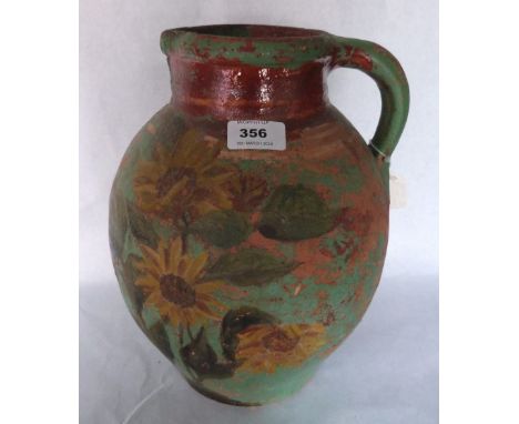 A 19th century Donyatt earthenware pitcher with painted decoration. 12½' high. Prov: Estate of Islwyn Watkins