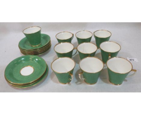 Ten green and foliate decorated coffee cups with eleven saucers. Early 20th century. One cup cracked