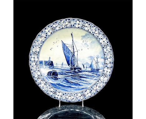 Delft style ceramic wall plate in blue and white with image of sailboats; berries and leaf design on lip. Royal Bonn backstam