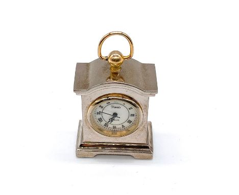 In silver and pale gold tone. Uses Roman numerals. Marked Xanadu to front of face. Dimensions: 1.25"L x 0.75"W x 2.25"HManufa