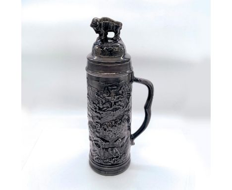 Depicts a hunting scene around body in relief, with bison finial to lid. Dimensions: 6"L x 4.75"W x 14.5"HCondition: Age rela