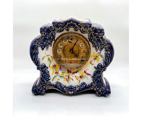 A impressive blue porcelain clock adorn with floral enamel and gilded gold accents. William L. Gilbert No. 411 backstamp. Dim