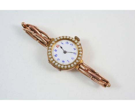 A LADY'S 9CT. GOLD WRISTWATCH BY ROLEX the circular white enamel dial with blue Arabic numerals, one red Arabic numerals at 1
