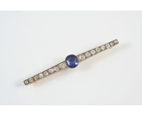 AN EDWARDIAN SAPPHIRE AND DIAMOND BROOCH the oval-shaped sapphire is millegrain set with graduated old brilliant-cut diamonds