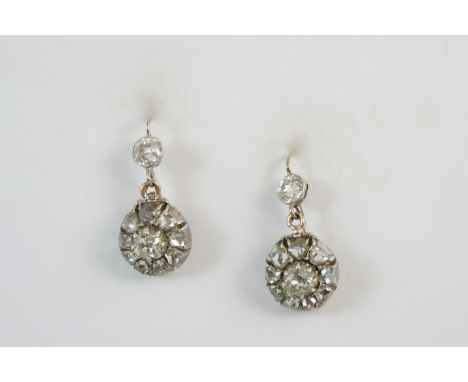 A PAIR OF VICTORIAN DIAMOND CLUSTER DROP EARRINGS each centred with an old brilliant-cut diamond within a surround of rose-cu