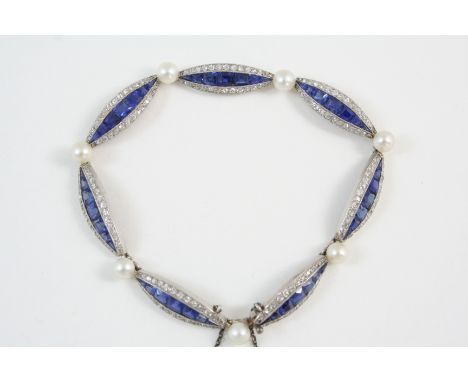 AN EARLY 20TH CENTURY SAPPHIRE, DIAMOND AND PEARL BRACELET the lozenge-shaped sections centred with calibre-cut sapphires wit