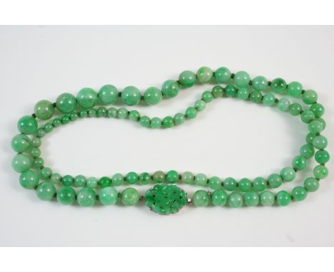 A SINGLE ROW GRADUATED JADE BEAD NECKLACE the jade beads graduate from approximately 4.7mm. to 9.3mm. to an oval-shaped carve