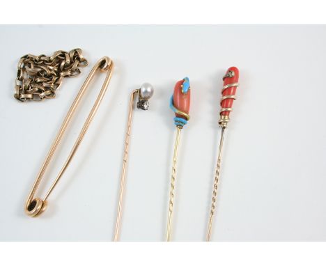 A CORAL AND GOLD STICK PIN mounted with a turquoise enamel snake, another coral stick pin, mounted with a gold snake, a pearl