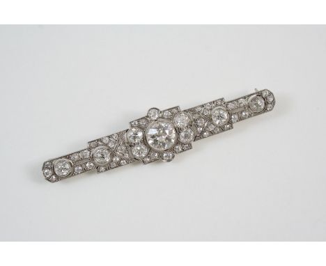 AN EDWARDIAN DIAMOND BROOCH the central collet set old brilliant-cut diamond weighs approximately 2.08 carats, within a surro