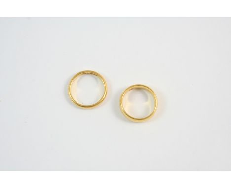 A 22CT. GOLD WEDDING BAND 7.1 grams, size K, together with another 22ct. wedding band, 4.0 grams, size N.