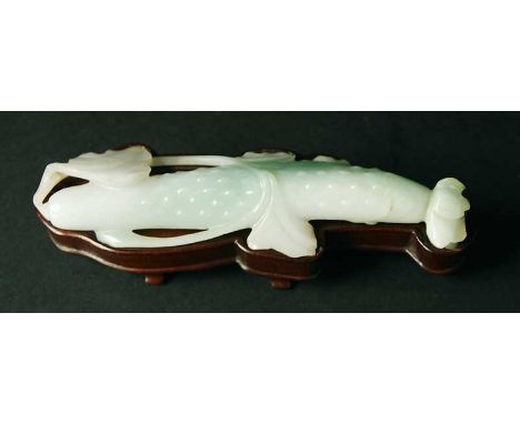 A WHITEISH GREEN JADE CARVING of a fruit with wood stand 5.75" (14.5cm)