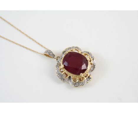 A RUBY AND DIAMOND PENDANT the oval-shaped ruby is set within a gold surround set with small diamonds, on a fine link neckcha