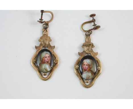 A PAIR OF ENAMEL DROP EARRINGS each depicting the head and shoulders of a young girl, in gilt metal, 4.5cm. long.