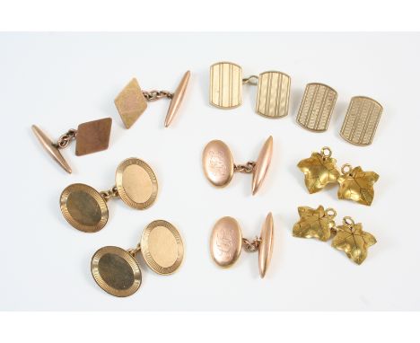 A PAIR OF 9CT. GOLD CUFFLINKS of oval shape and with engine turned decoration, together with three other pairs of 9ct. gold c