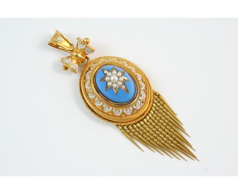 A VICTORIAN GOLD AND ENAMEL PENDANT the domed section of turquoise enamel with half pearl star decoration, within a gold surr