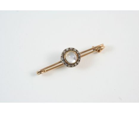 A MOONSTONE AND DIAMOND BROOCH the circular cabochon moonstone is set within a surround of rose-cut diamonds, in silver and g