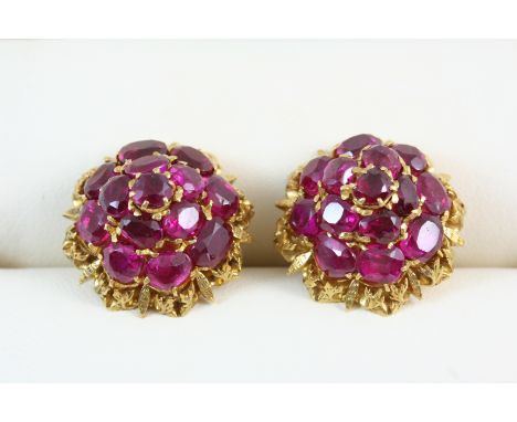 A PAIR OF RUBY AND GOLD CLUSTER EARRINGS of dome shape, each set with circular-cut rubies, in gold. With post fittings.