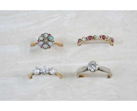A DIAMOND THREE STONE RING the three circular-cut diamonds are set in 18ct. gold and platinum, size M, an opal, ruby and diam