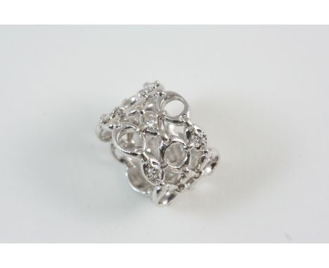 AN 18CT. WHITE GOLD RING BY CHRISTIAN DIOR of openwork design, signed Dior to the inside and numbered B2096 51. Size L. With 