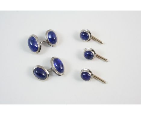 A PAIR OF SAPPHIRE CUFFLINKS each link is set with an oval-shaped cabochon sapphire, in white gold, together with three match