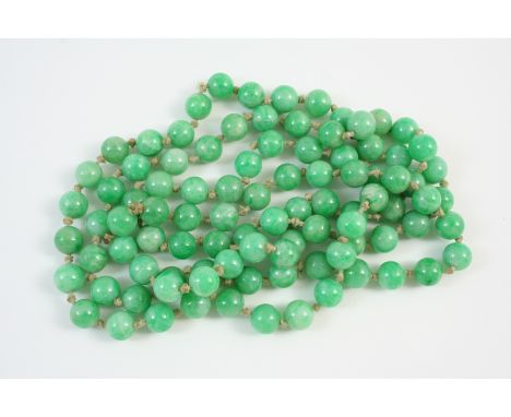 A SINGLE ROW UNIFORM JADE BEAD NECKLACE the jade beads measure approximately 8.7mm., 108cm. long.