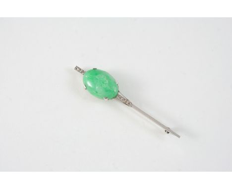 A JADE AND DIAMOND BROOCH set with an oval shaped carved section of jade and with rose-cut diamonds, 6.25cm. long.