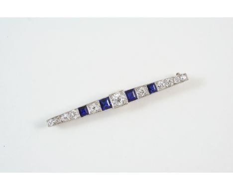 A SAPPHIRE AND DIAMOND BROOCH set with graduated circular old brilliant-cut diamonds and graduated square-shaped sapphires, 5