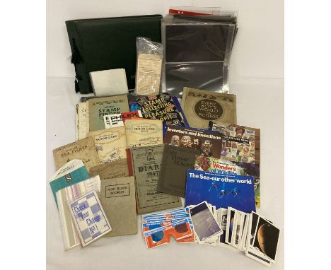 A box of assorted vintage ephemera relating to coins, stamps and collectors cards.  To include: cigarette and tea card albums