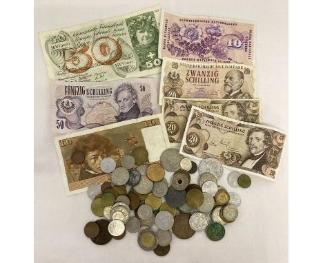 A collection of vintage and antique foreign bank notes and coins.  To include examples from Switzerland, Austria, France Germ