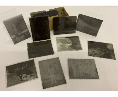 A small collection of vintage glass photographic plates to include ships.  