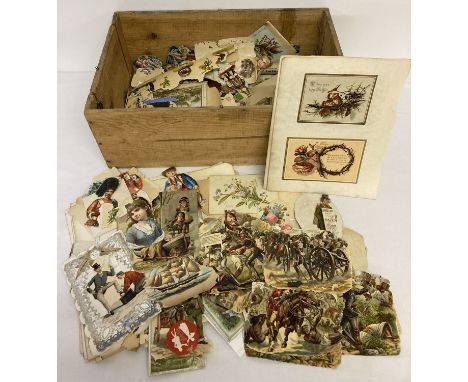 A vintage wooden crate containing a quantity of assorted scraps and pages from a scraps book.  