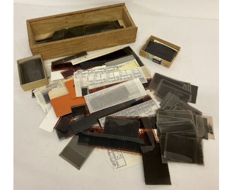 A box of assorted vintage photographic negatives.  