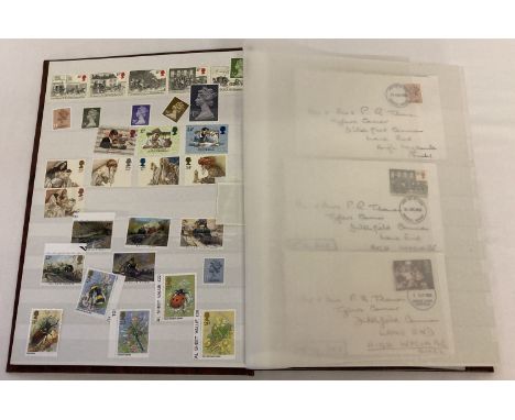 A large brown album containing 400 British unused stamps and 8 first day covers.  Stamps include sets, blocks and panes. Most