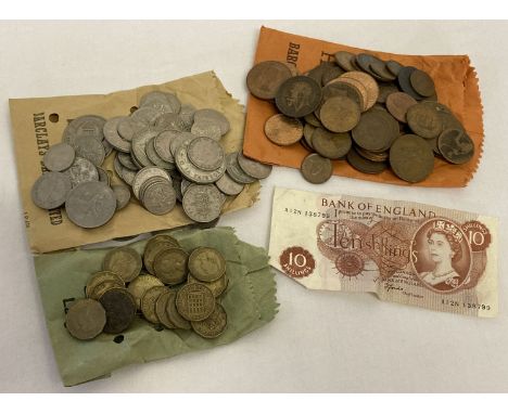 A collection of vintage coins and a 10 shilling note.  Coins include pennies, half pennies, sixpences, three pence's, farthin