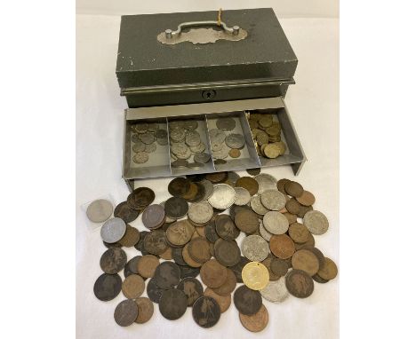 A green metal cash tin containing a collection of antique and vintage coins.  Sovereign heads of Victoria, Edward VIII, Georg