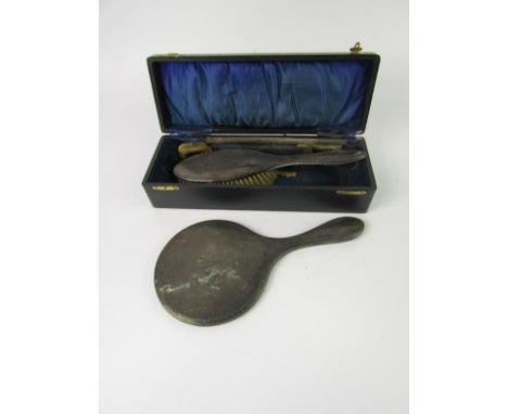 A George V silver backed hand mirror, hair brush and comb, initial engraved, part cased, Birmingham 1919/20.